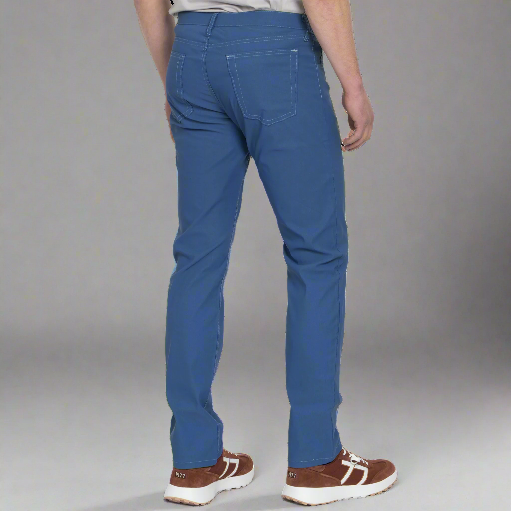 Back view of light blue technical jeans showing rear pockets and Horween leather patch at the waistband.