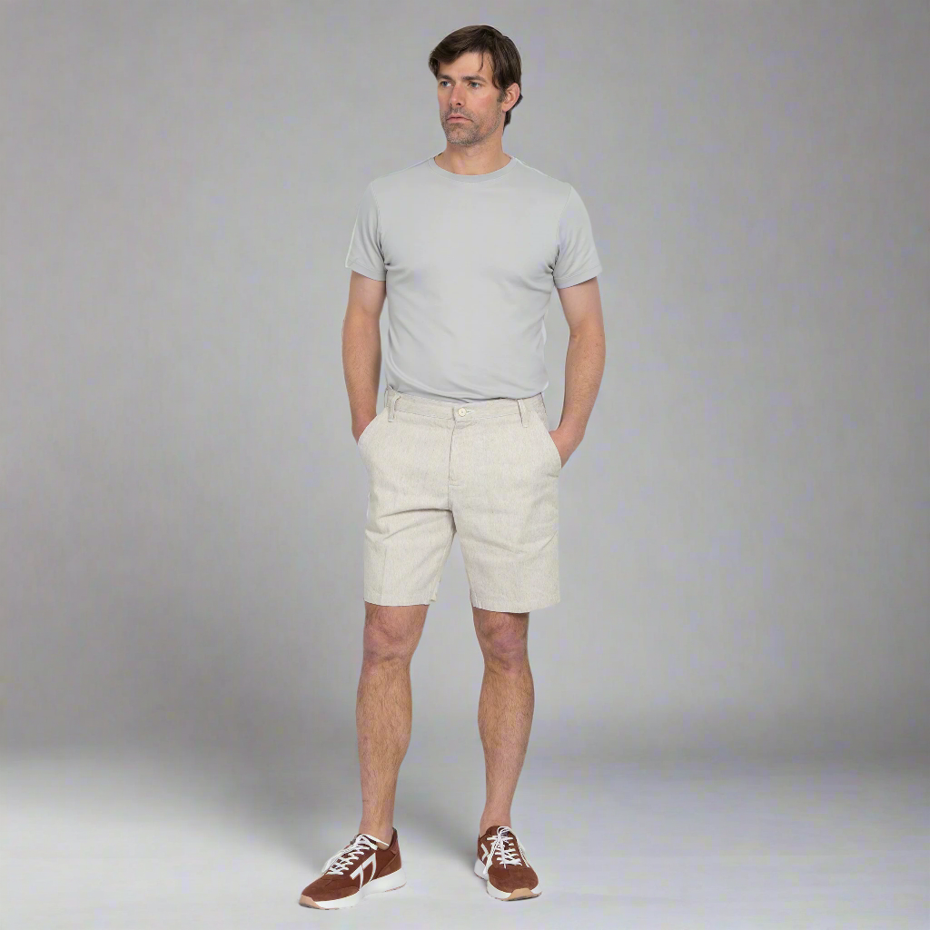 Close-up of the custom wood button and waistband on the hemp shorts.