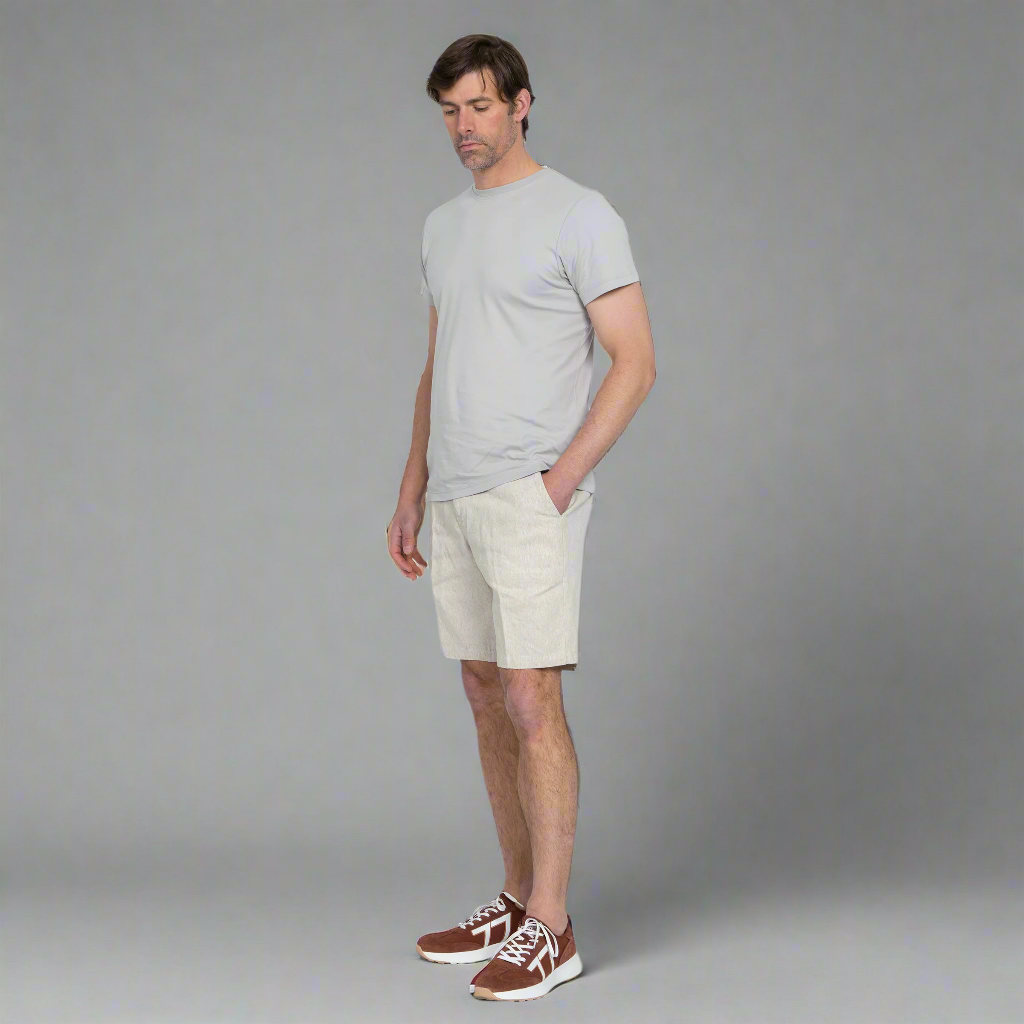 Front view of the hemp shorts on a model, showing two front pockets and custom wood button.