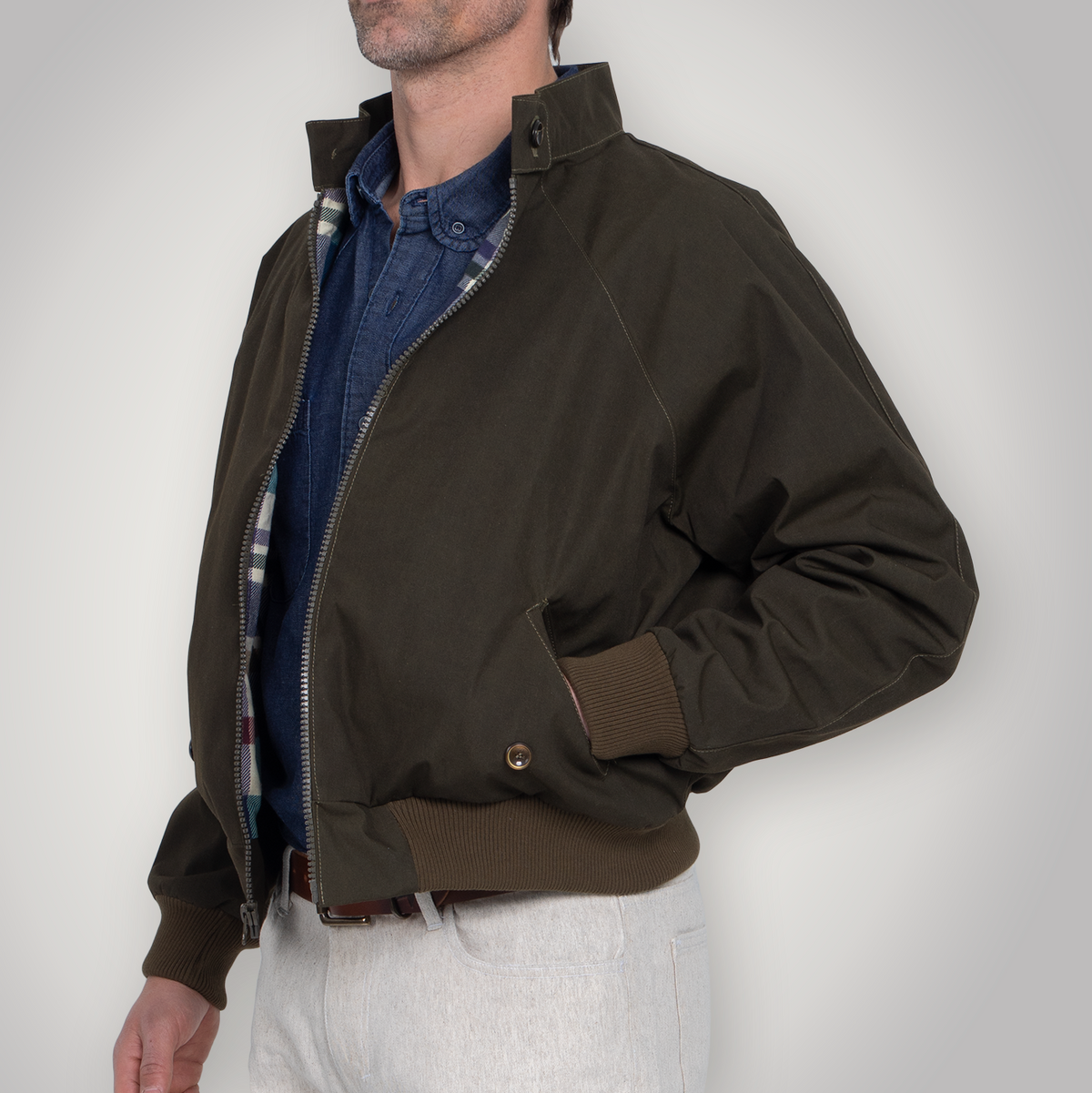 Olive Harrington jacket shown from the front, buttoned, with rounded collar and flap pockets.