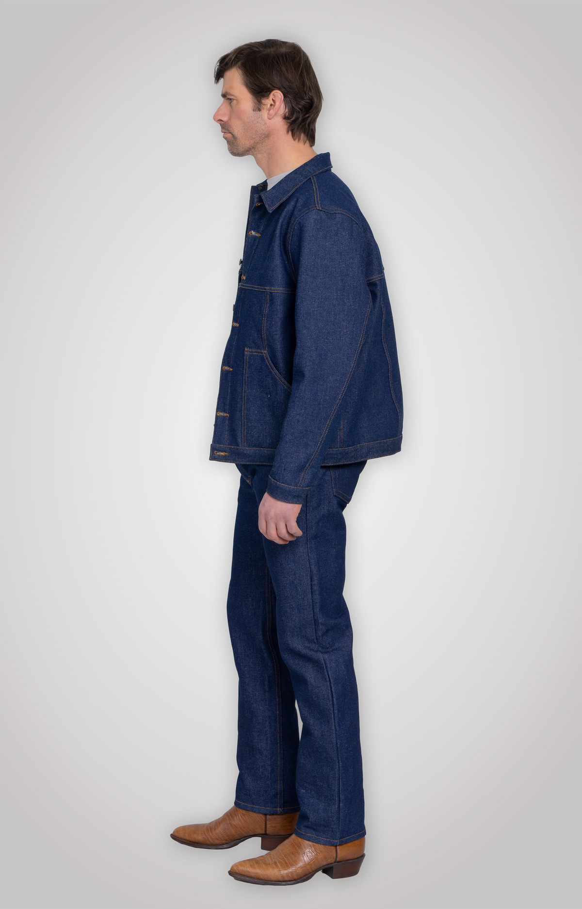 Model wearing the rigid denim jacket over a t-shirt, hitting just below the waist.