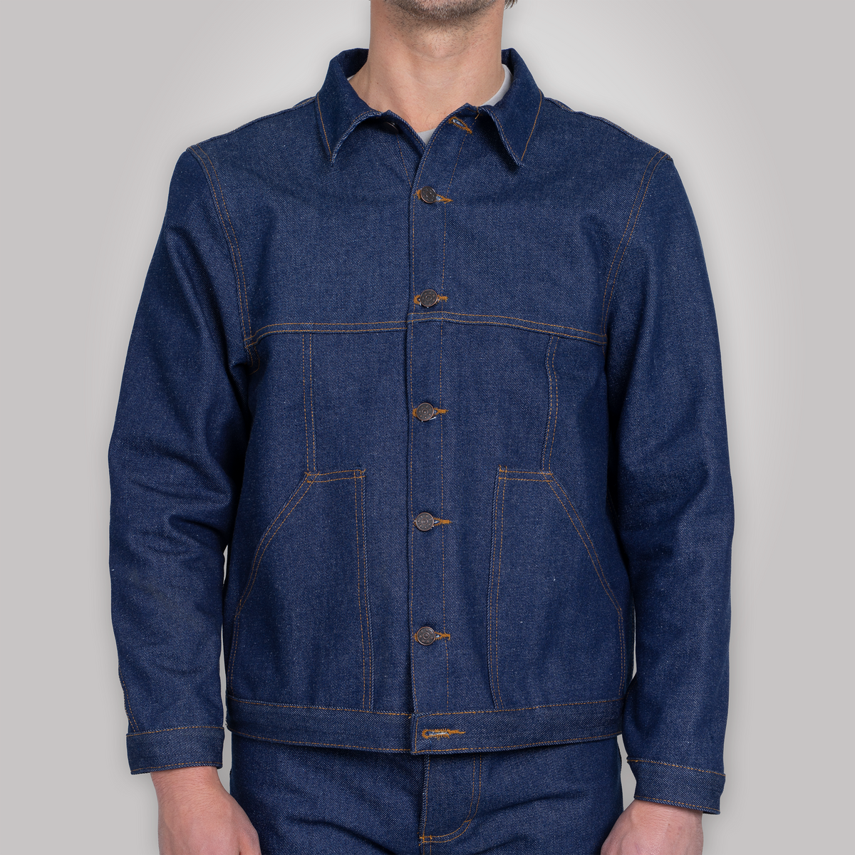 Back view of the rigid denim jacket showing yoke and waist band.
