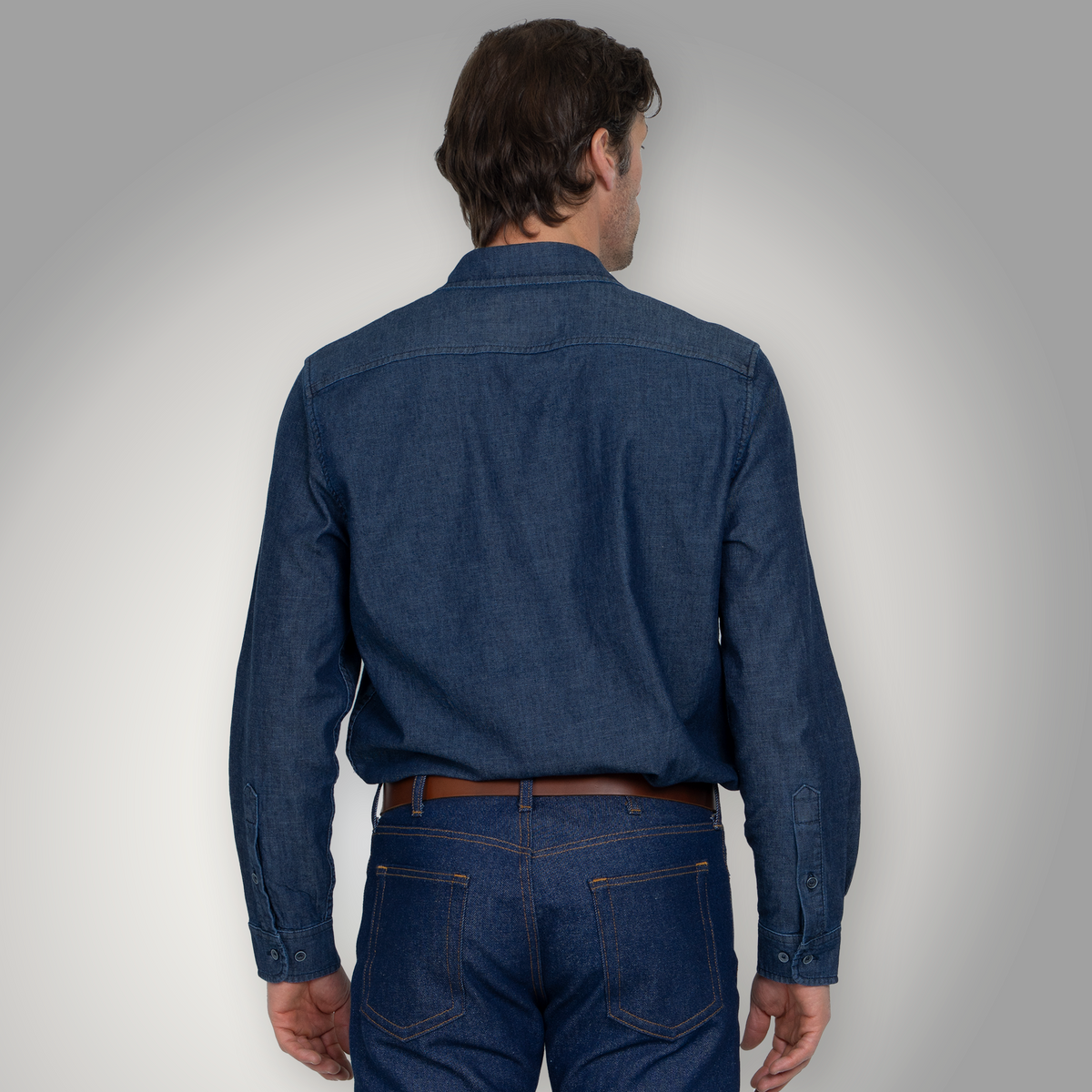Side view of the fitted chambray shirt showing the narrower profile through the waist