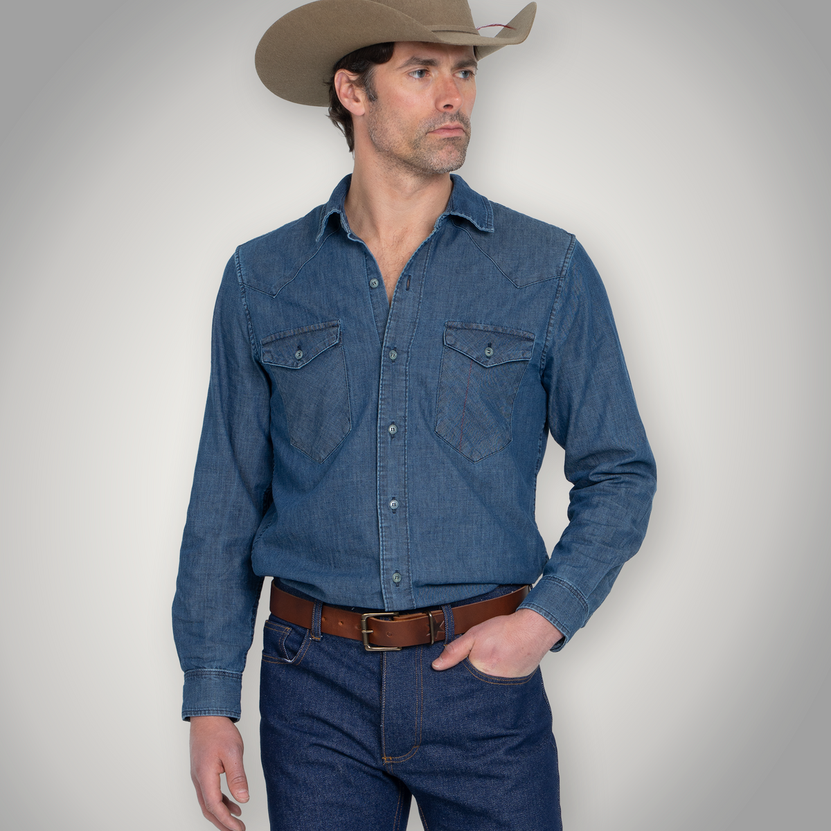 Detail of the chest pocket and accent stitching on the chambray shirt