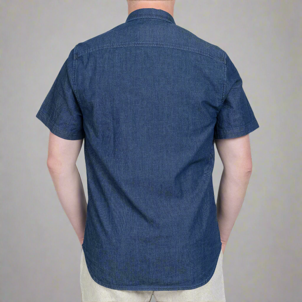 Close up of the left chest pocket with button closure on the chambray shirt.