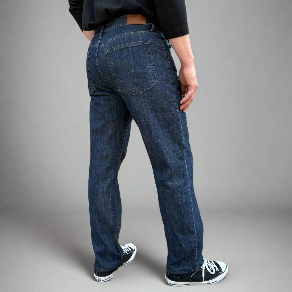 Back view of stone wash relaxed fit jeans showing back pockets and leather patch