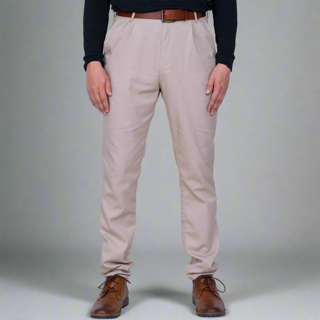 Khaki high rise chino pants shown front on a model, tailored fit through the thigh and tapered leg.