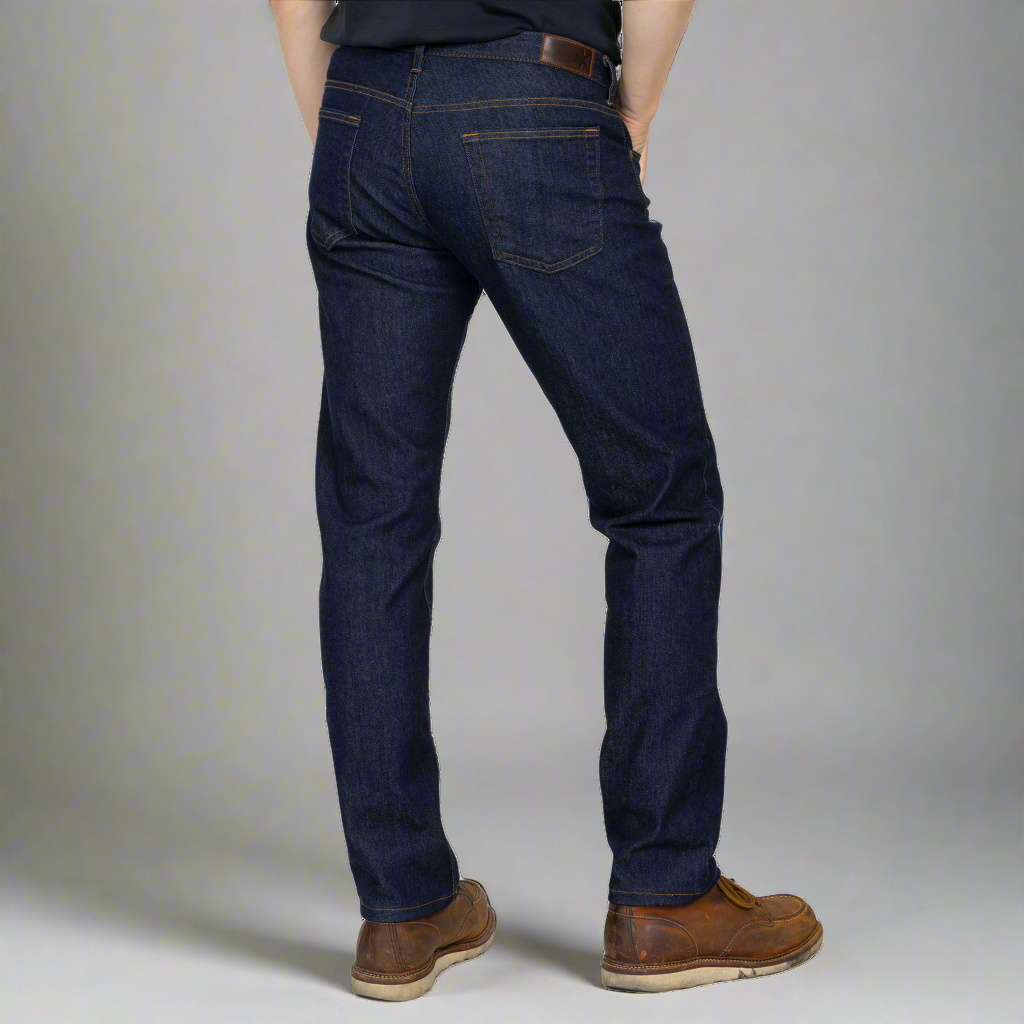 Detail of front pocket, YKK zipper fly and waistband on dark wash jeans