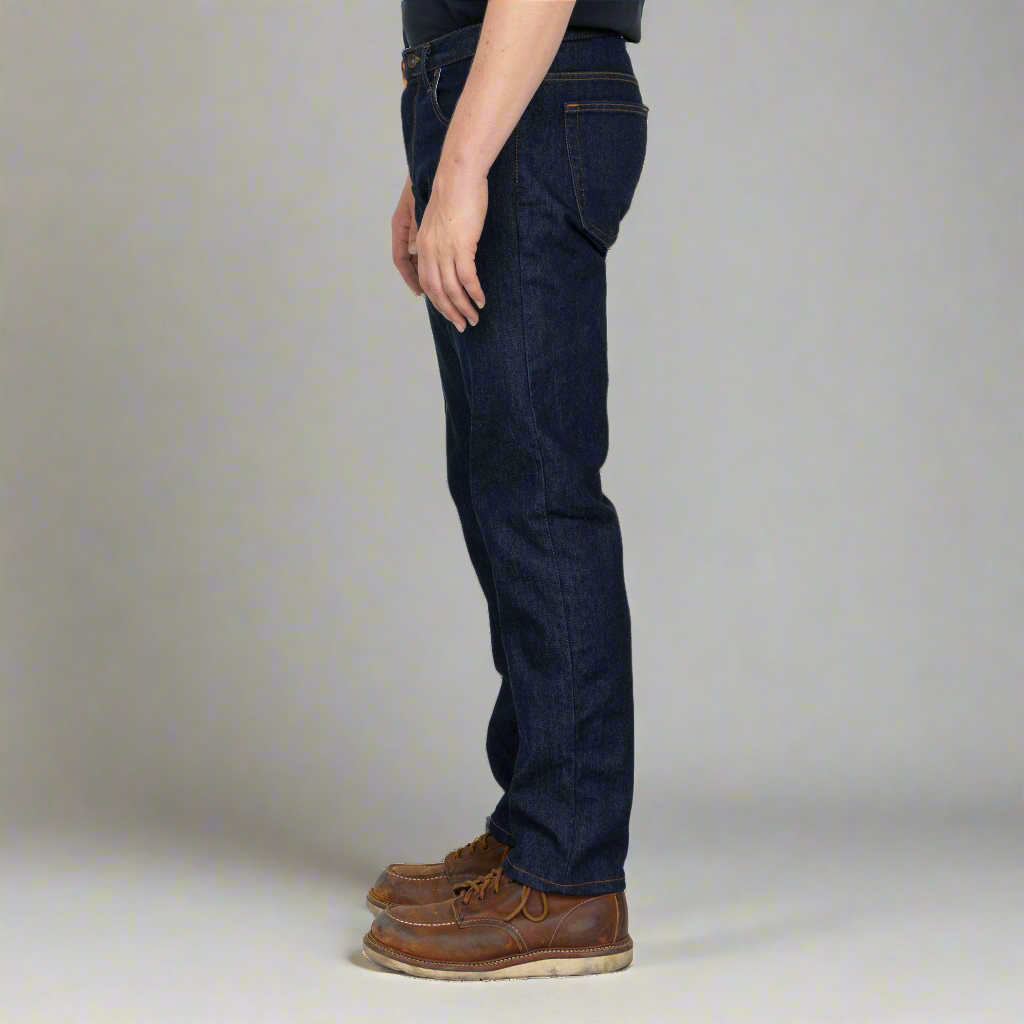 Close-up of dark stretch denim fabric and stitching on Tailored Fit jeans