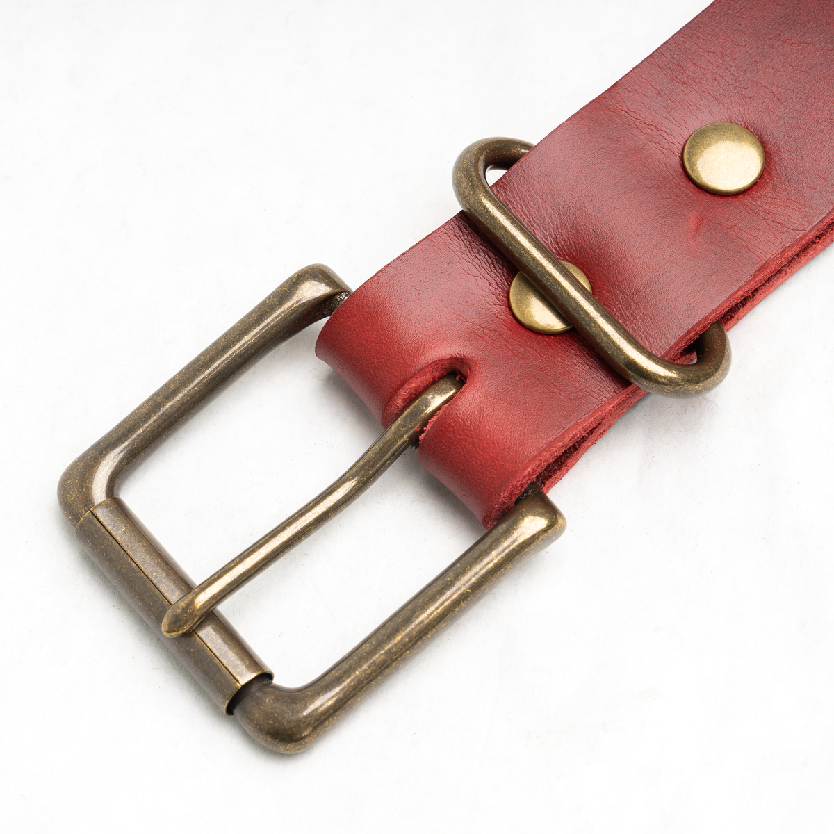 Red leather belt worn through the loops of Dearborn Denim jeans