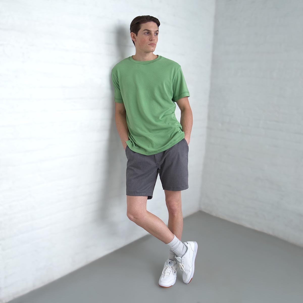 Man wearing grey chino shorts, side view showing the trim thigh