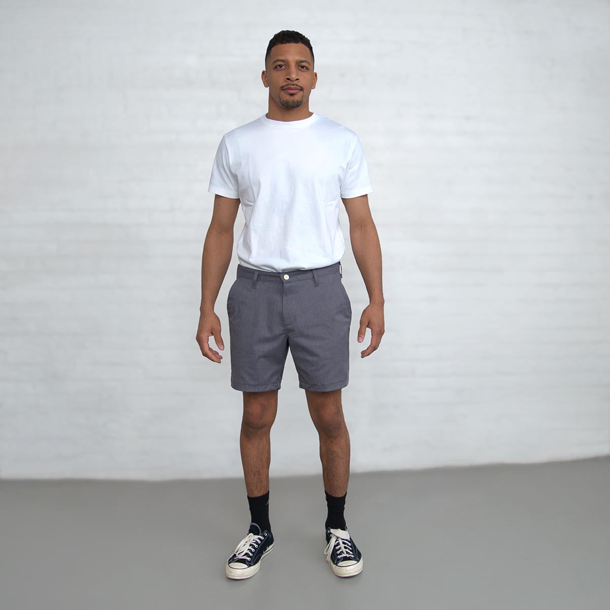 Man wearing grey chino shorts, front view from the waist down