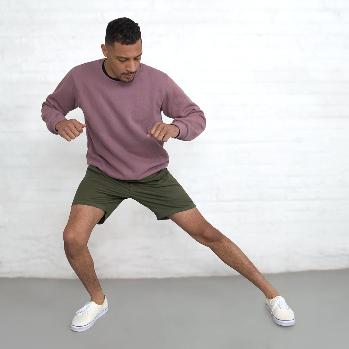 Back view of olive chino shorts showing welt pockets with button closures.