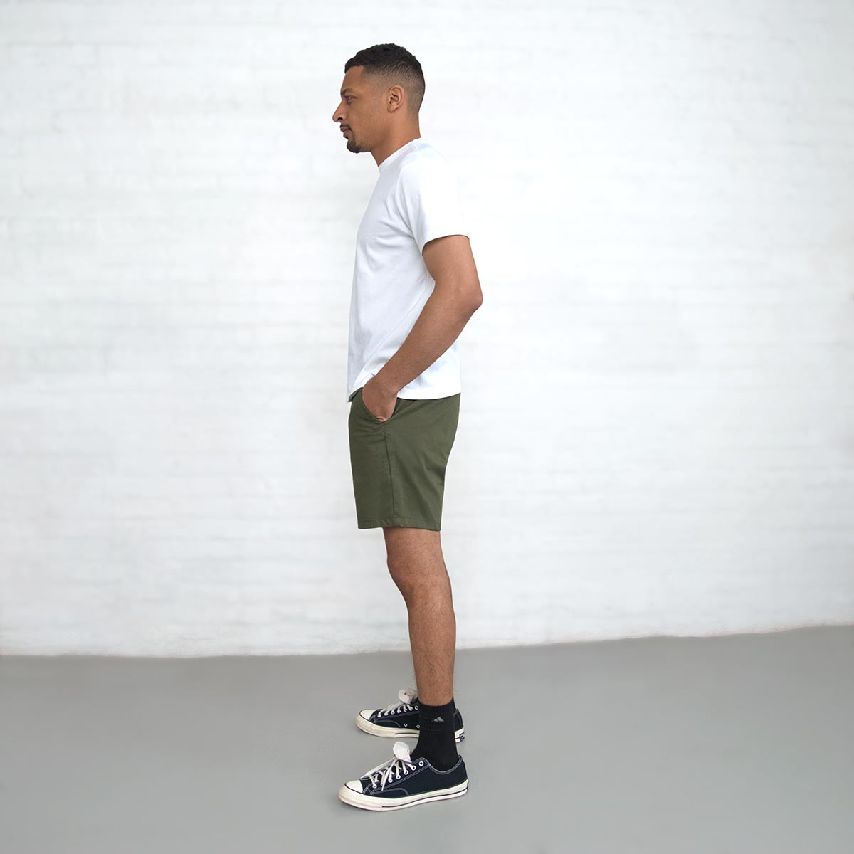 Olive chino shorts shown with a shirt for a full outfit view.