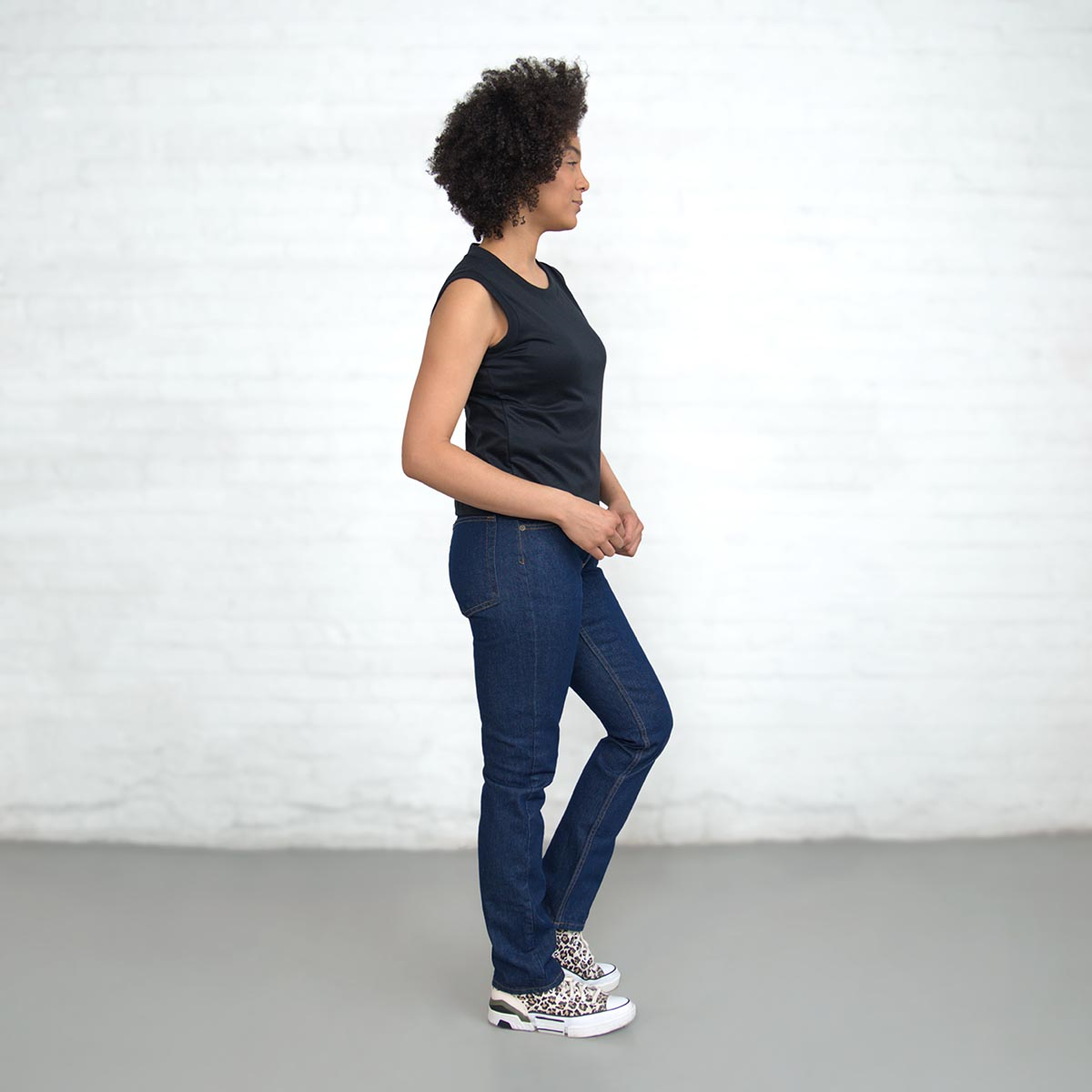 Side view showing the cropped hem and fitted arm hole
