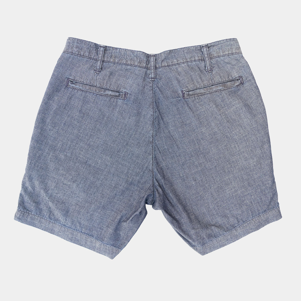 Man wearing chambray shorts, front view showing tailored fit and 7 inch inseam