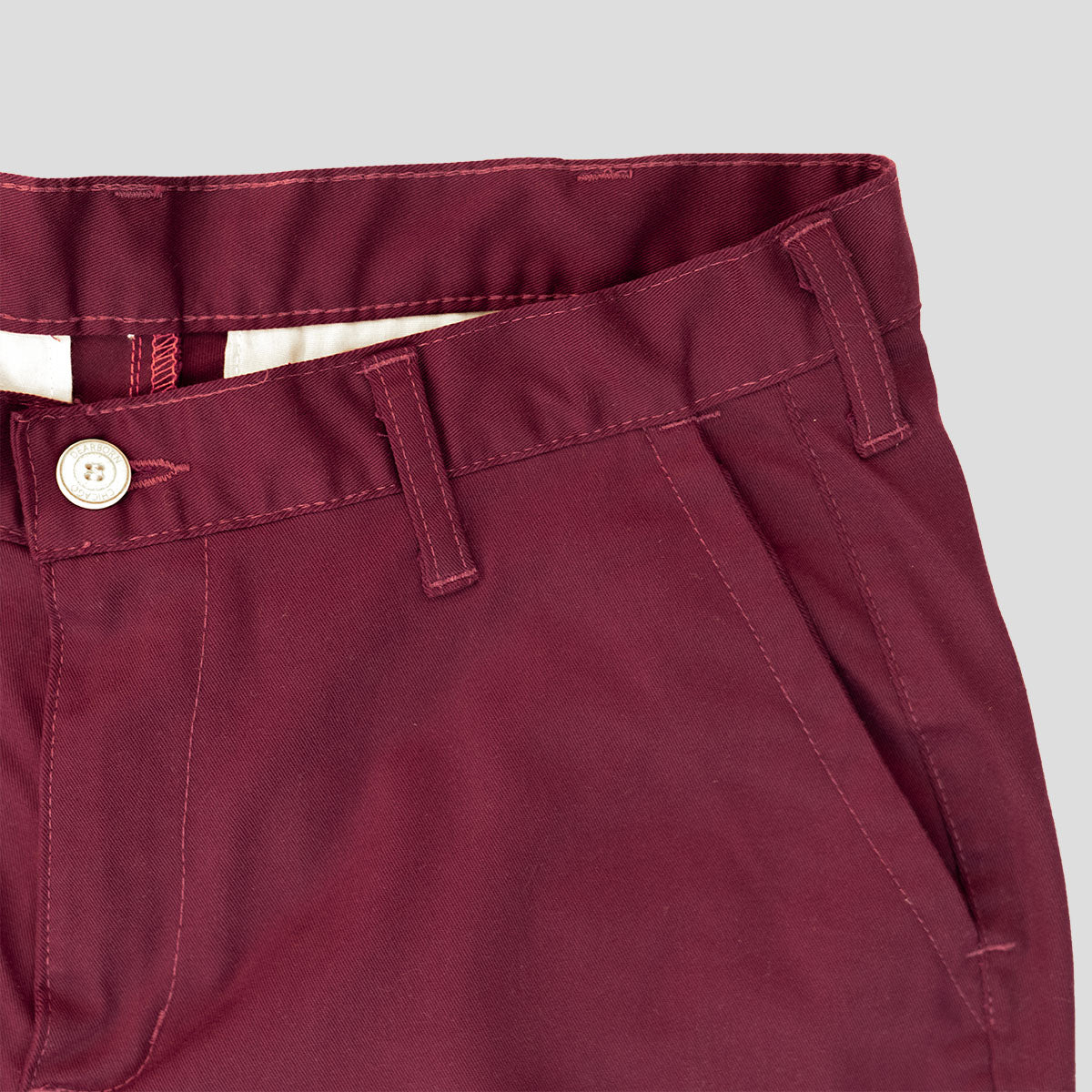 Man wearing wine stretch chinos, full-length side view