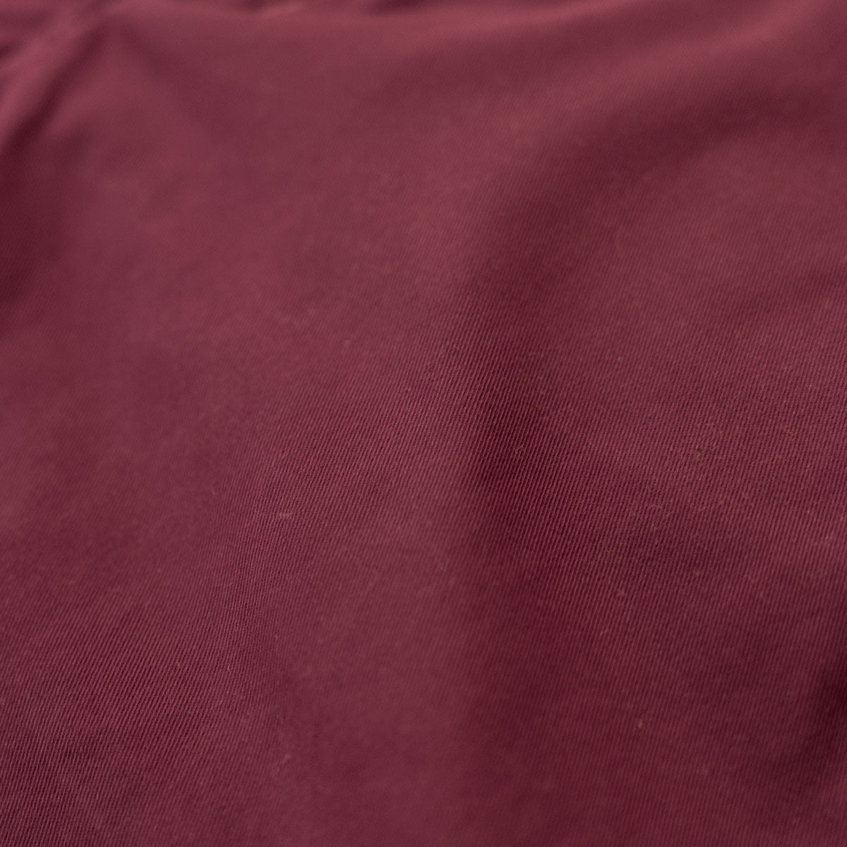 Front pocket detail on wine stretch chinos