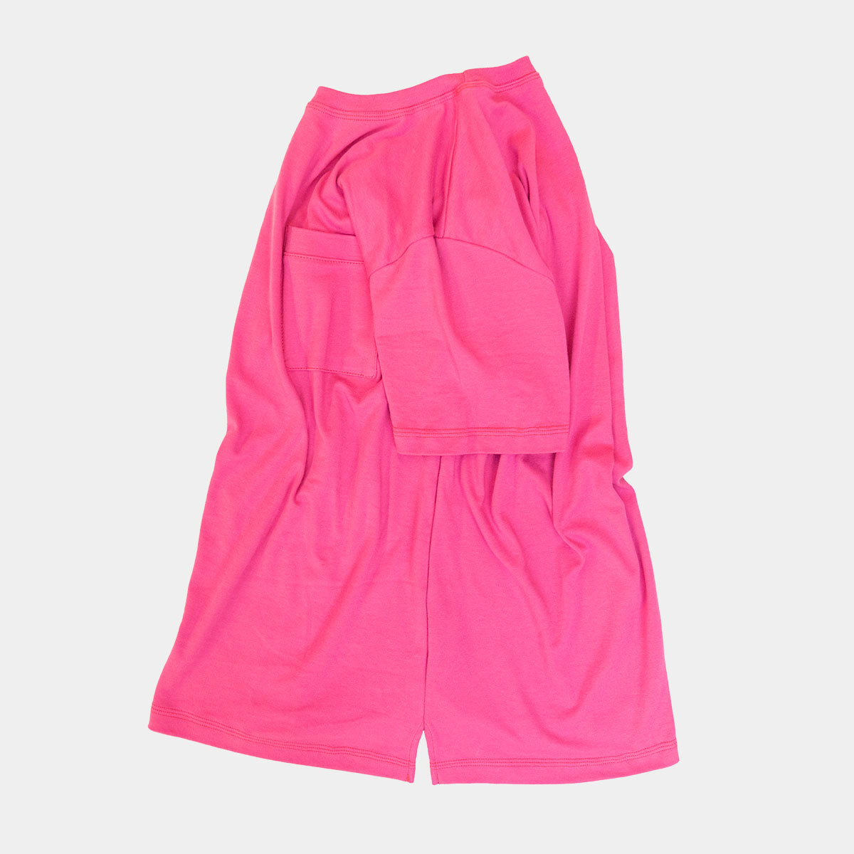 Close-up of the collar and shoulder seam on the magenta tee