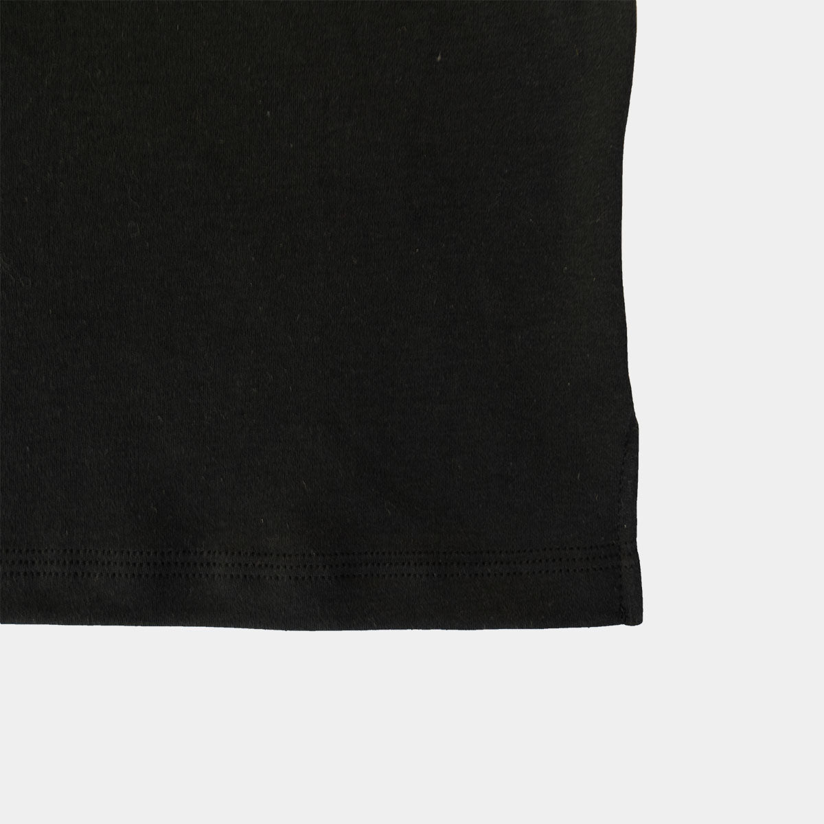 Close-up of the left chest patch pocket on the black Supima cotton T-shirt.