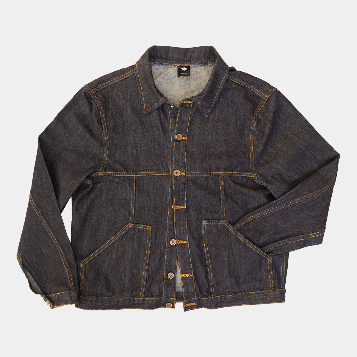 Dark wash denim jacket worn open over a sweatshirt