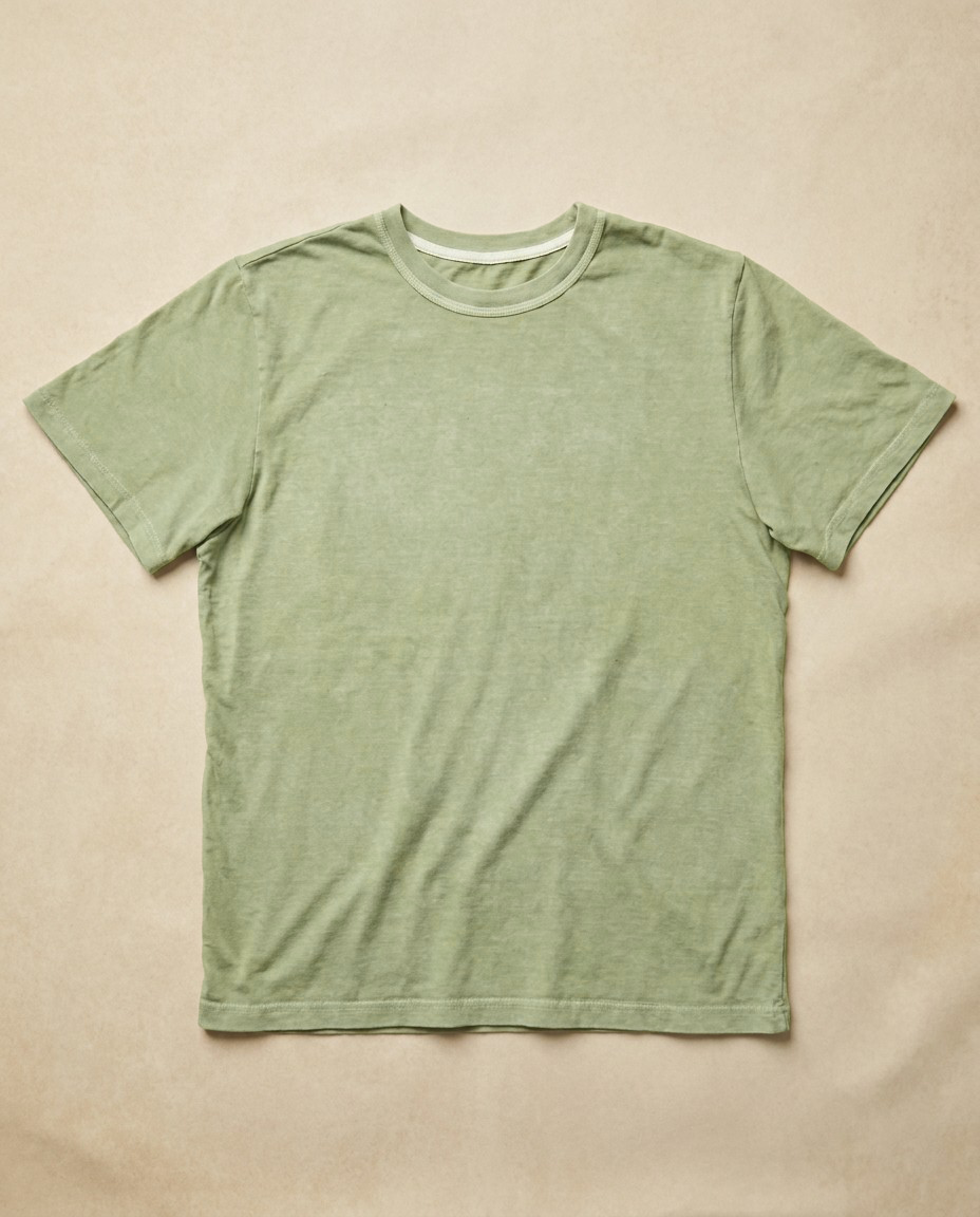 Moss green t-shirt worn on a model, showing the slight taper through the body.