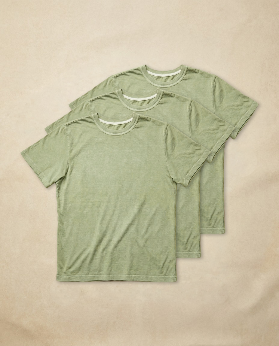 Moss green cotton t-shirt laid flat, showing the crew collar and mid bicep sleeves.