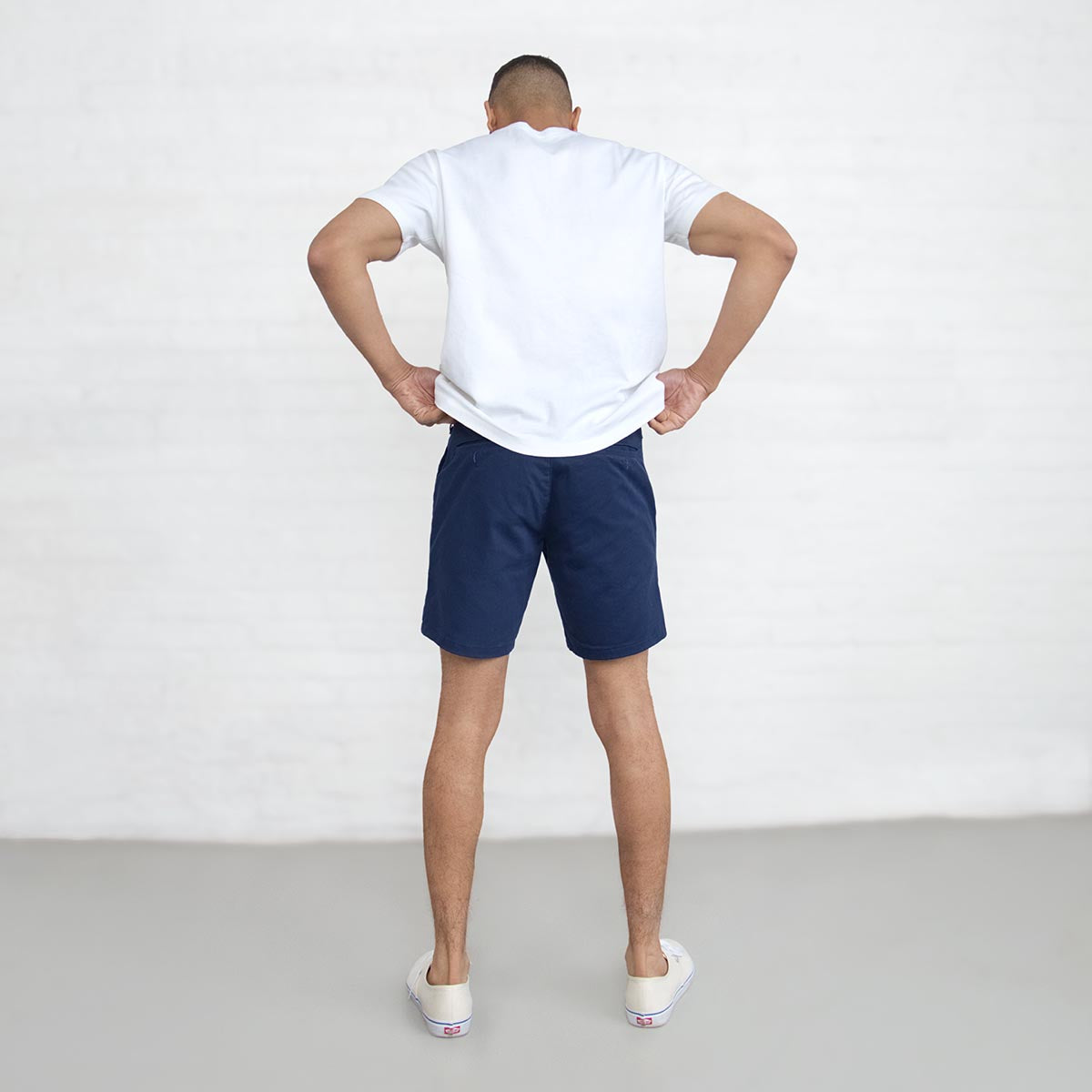 Close-up of the branded Italian button and YKK America zipper fly on navy chino shorts.
