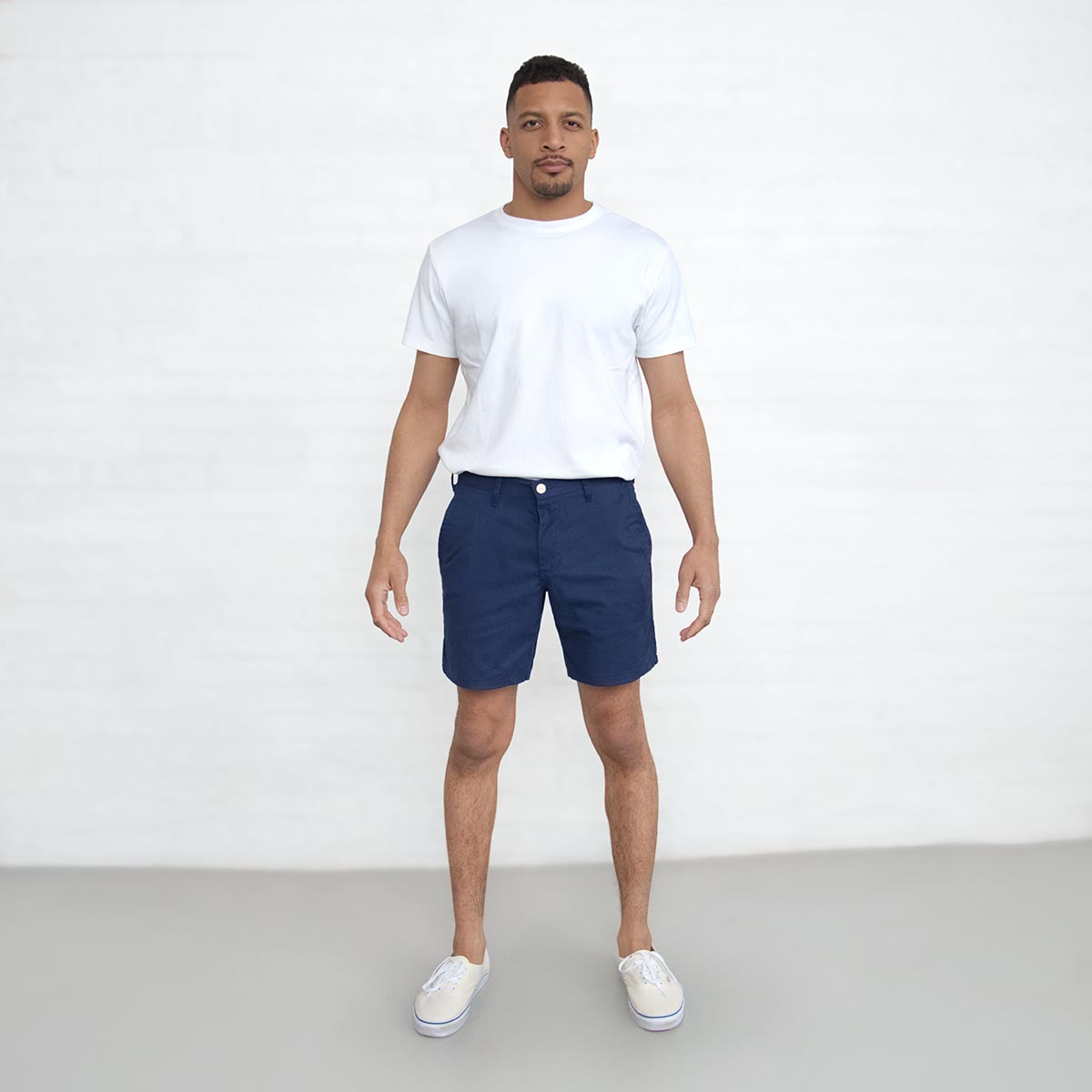Back view of navy chino shorts with button closure welt pockets.