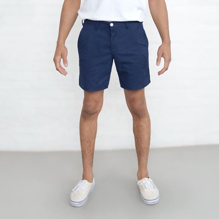 Navy chino shorts laid flat, front view, showing 7 inch length and button closure.