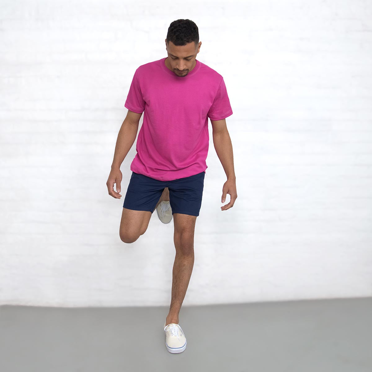 Model wearing navy chino shorts, front view from the waist down.