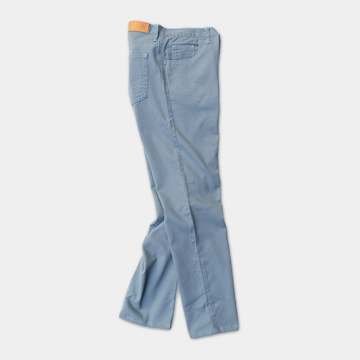 Side view of the tailored fit jeans showing the taper from knee to leg opening.