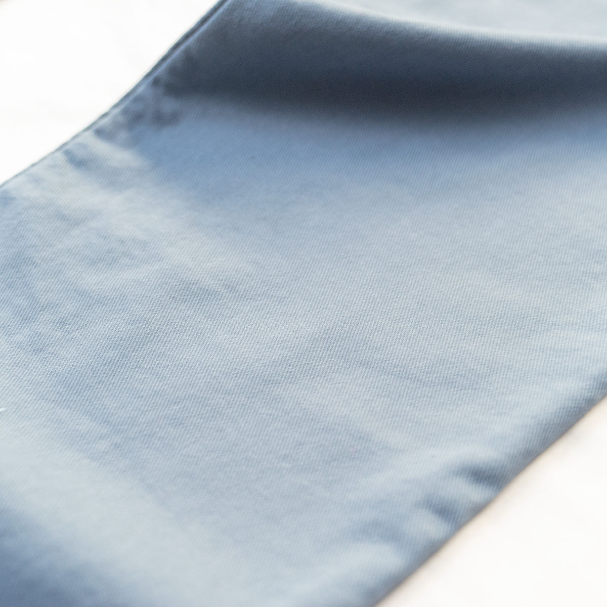 Slate tailored fit jeans worn with the cuff and hem visible at the shoe.