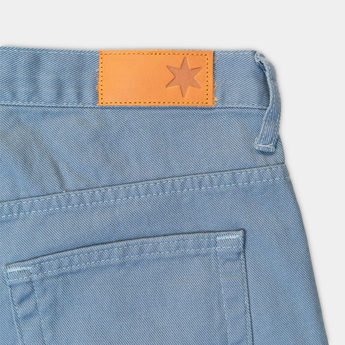 Close-up of the brushed 10oz slate denim fabric and stitching.
