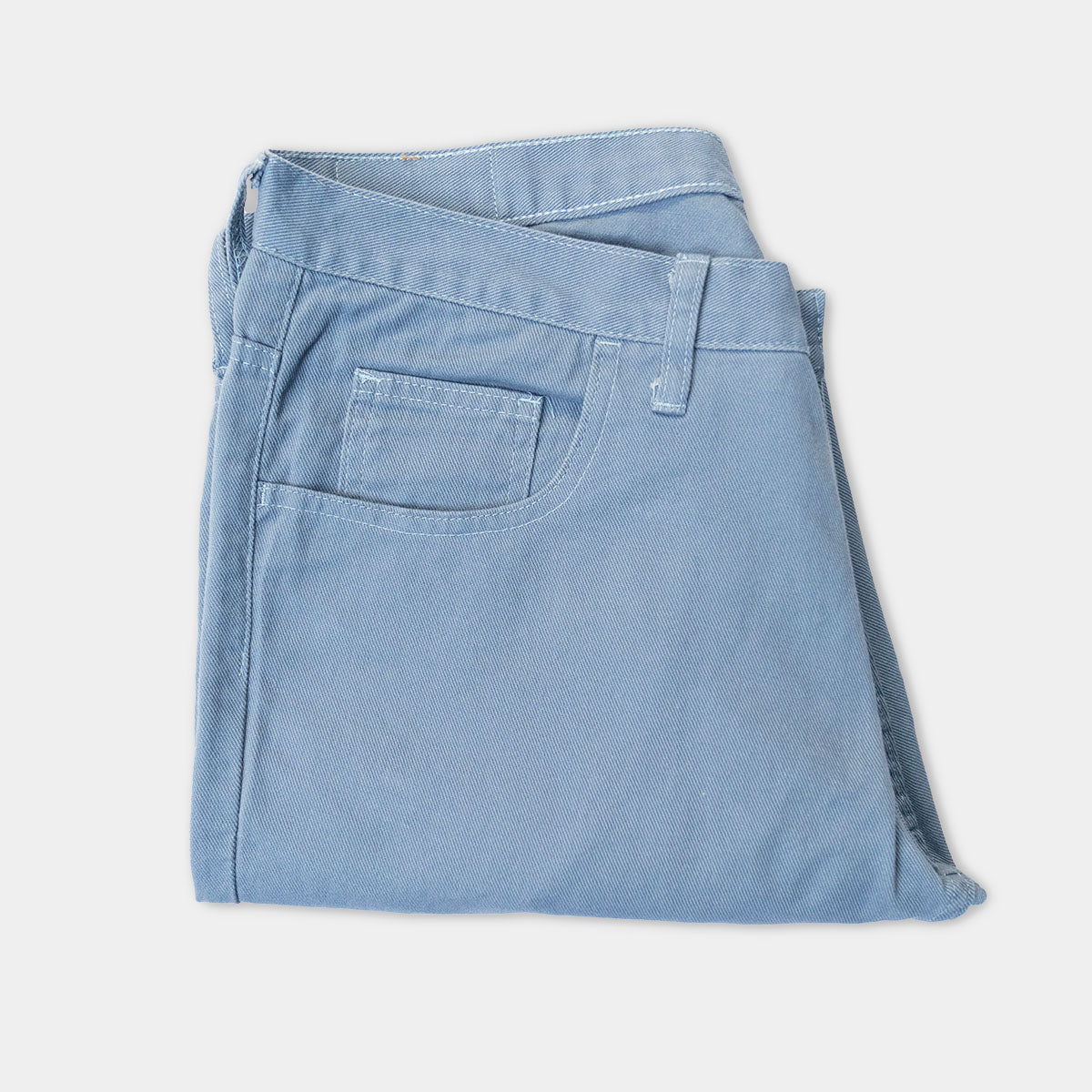 Close-up of the front pocket and belt loops on slate cotton denim jeans.