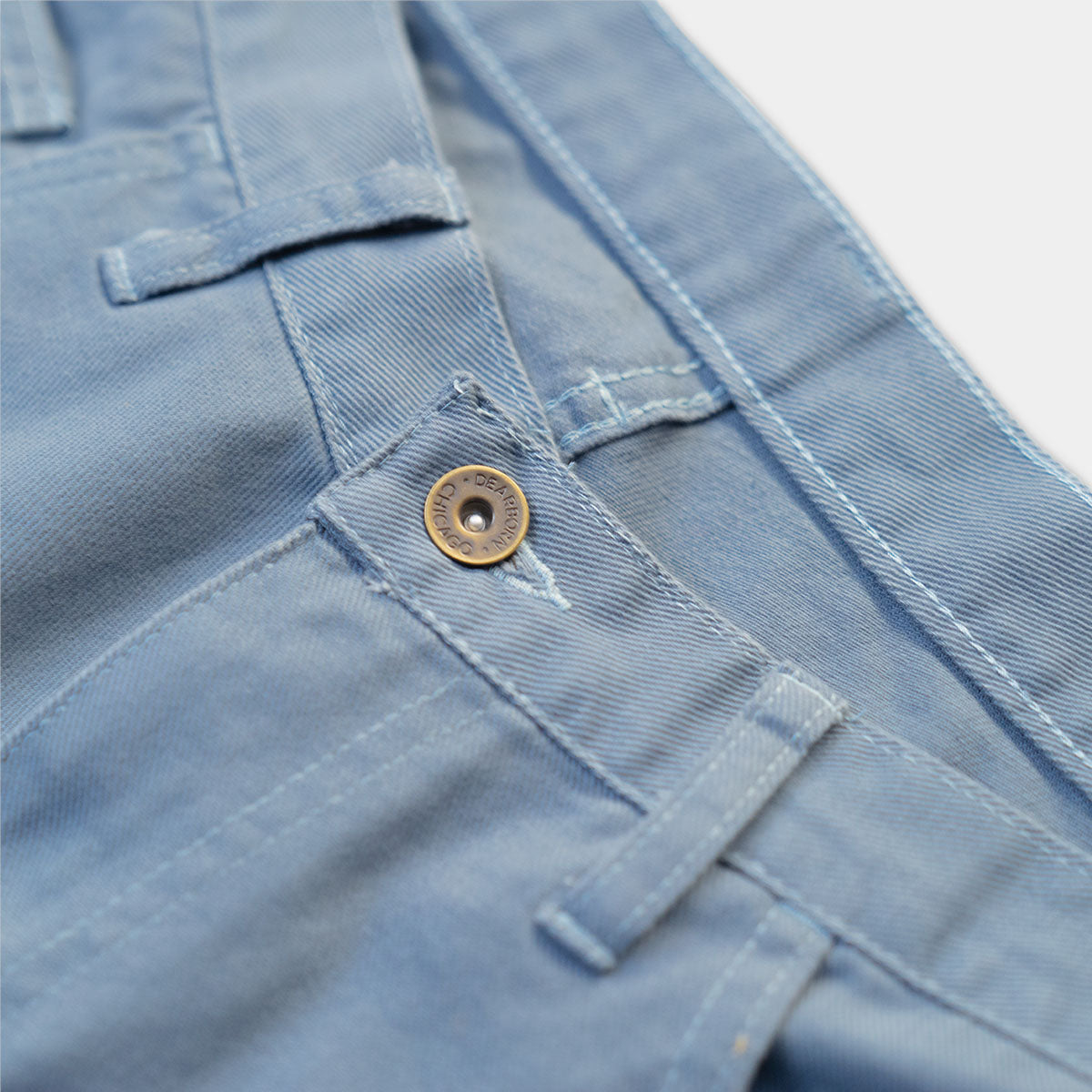 Detail of the Dearborn Denim button and YKK zipper fly on slate cotton jeans.
