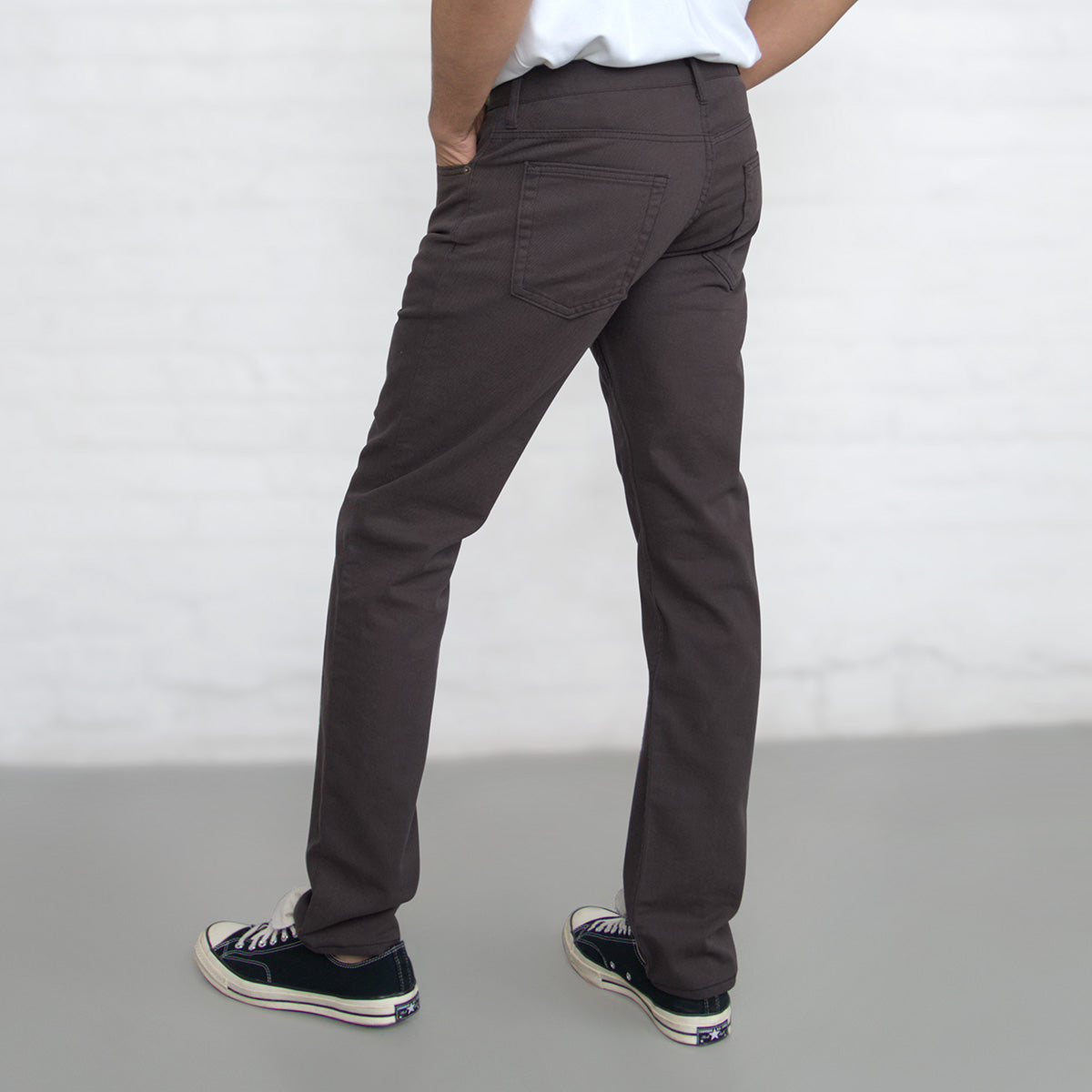 Horween leather patch stitched to the back waistband of the espresso jeans.
