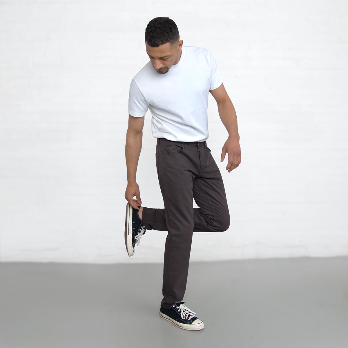 Cuff and leg opening of the espresso jeans shown over shoes.