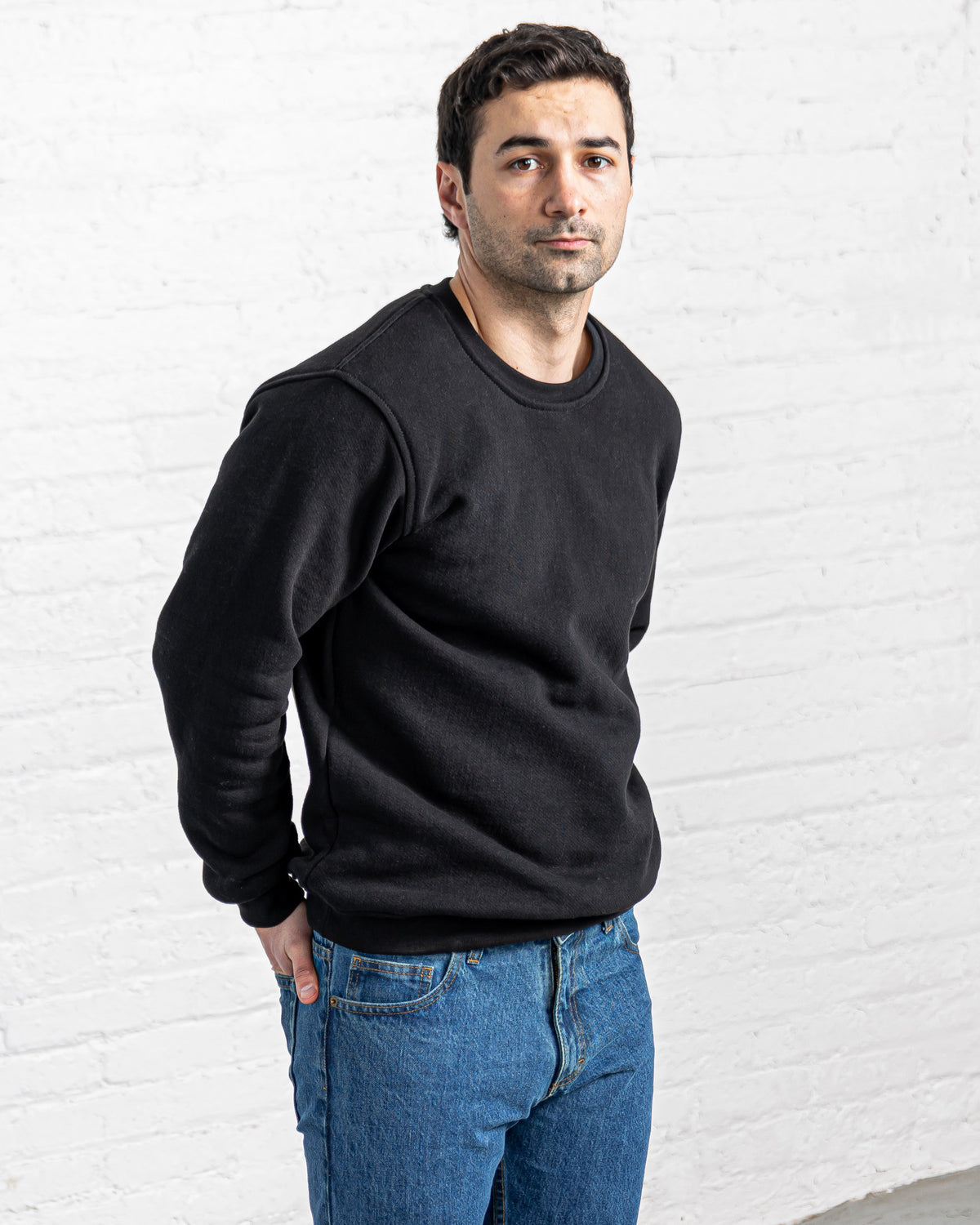 Black collegiate crewneck sweatshirt in heavy cotton fleece, shown front on