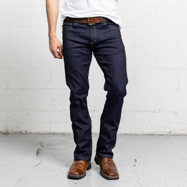 Dark wash boot cut jeans shown flat, front view, with five pockets and a leather patch at the waistband.