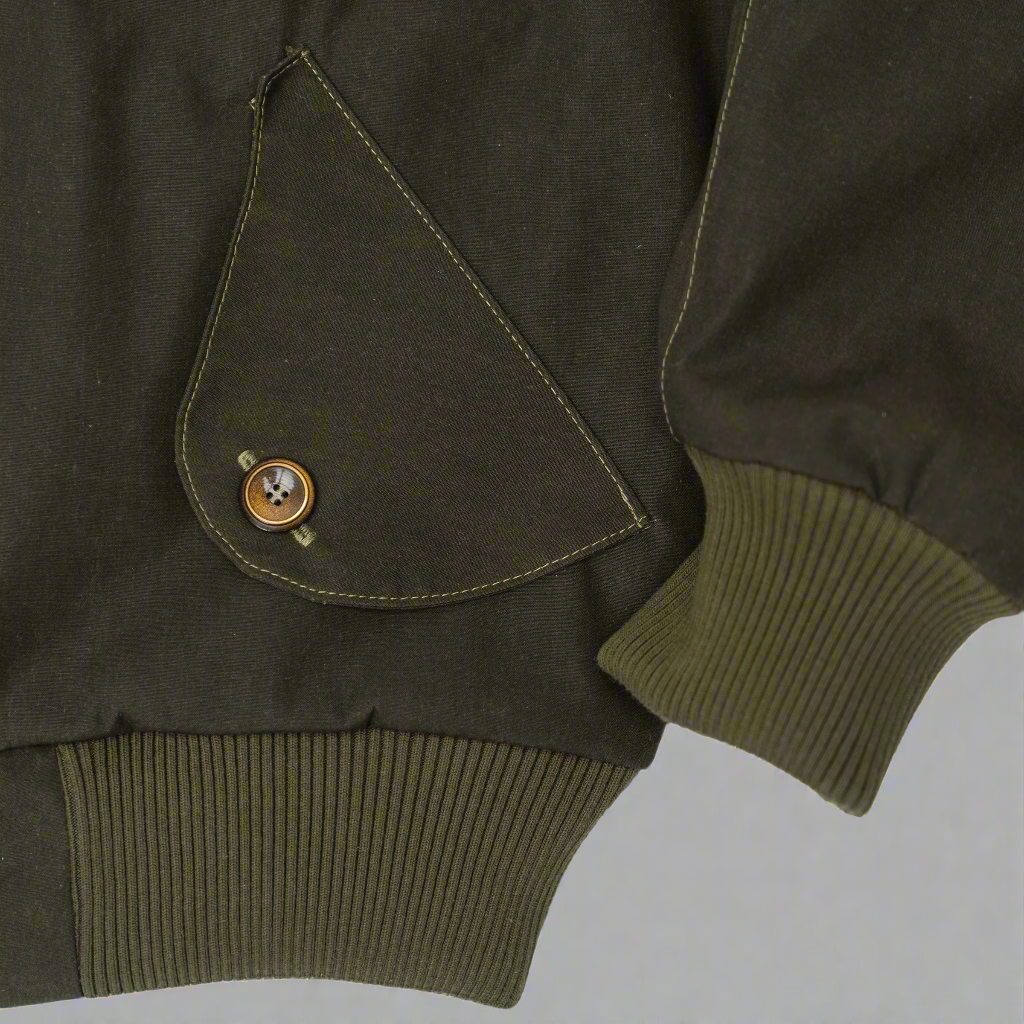 Cuff detail on the sleeve of the olive Harrington jacket.