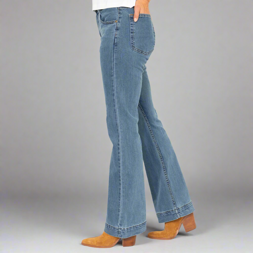 Back view of the light wash flare jeans showing the oversize back pockets and fitted seat.