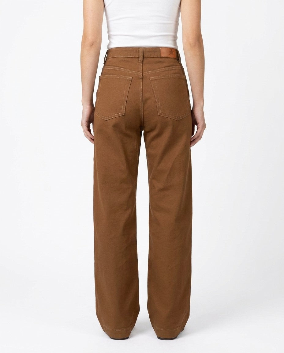 Back view of brown wide leg jeans showing oversize back pockets and Horween leather patch.