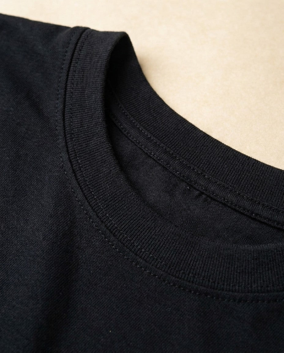 Close-up of the fine gauge interlock knit fabric surface in black.