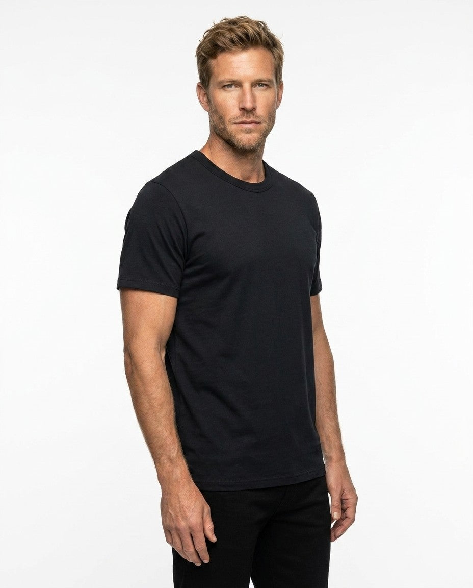 Man wearing the black Supima t-shirt, showing mid bicep sleeve and slight taper through the body.