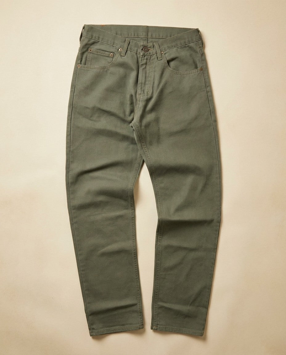 Close-up of the Scout denim showing the gold leaf button, YKK zipper fly and stitching detail.