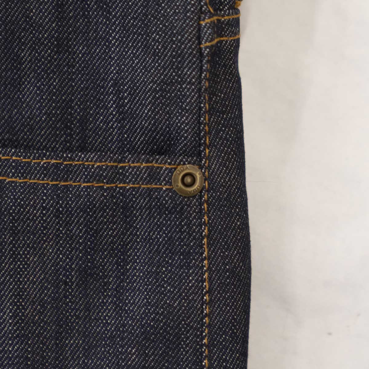 Model wearing the tailored fit raw selvage jeans, full length.