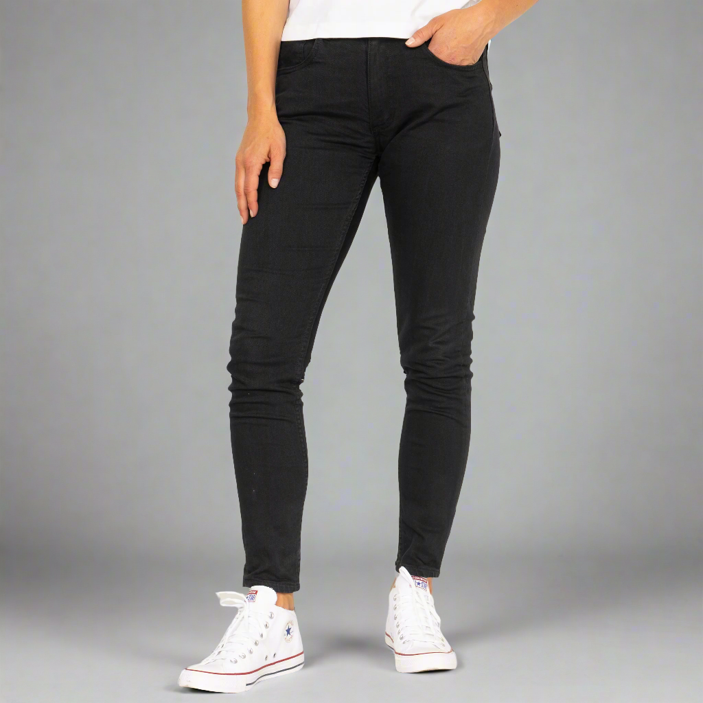 Back view of black skinny jeans showing rear pockets and Horween leather patch at the waistband.