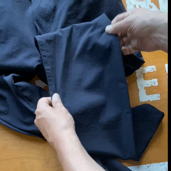 Close-up of navy nylon stretch fabric showing the tight weave and smooth surface.