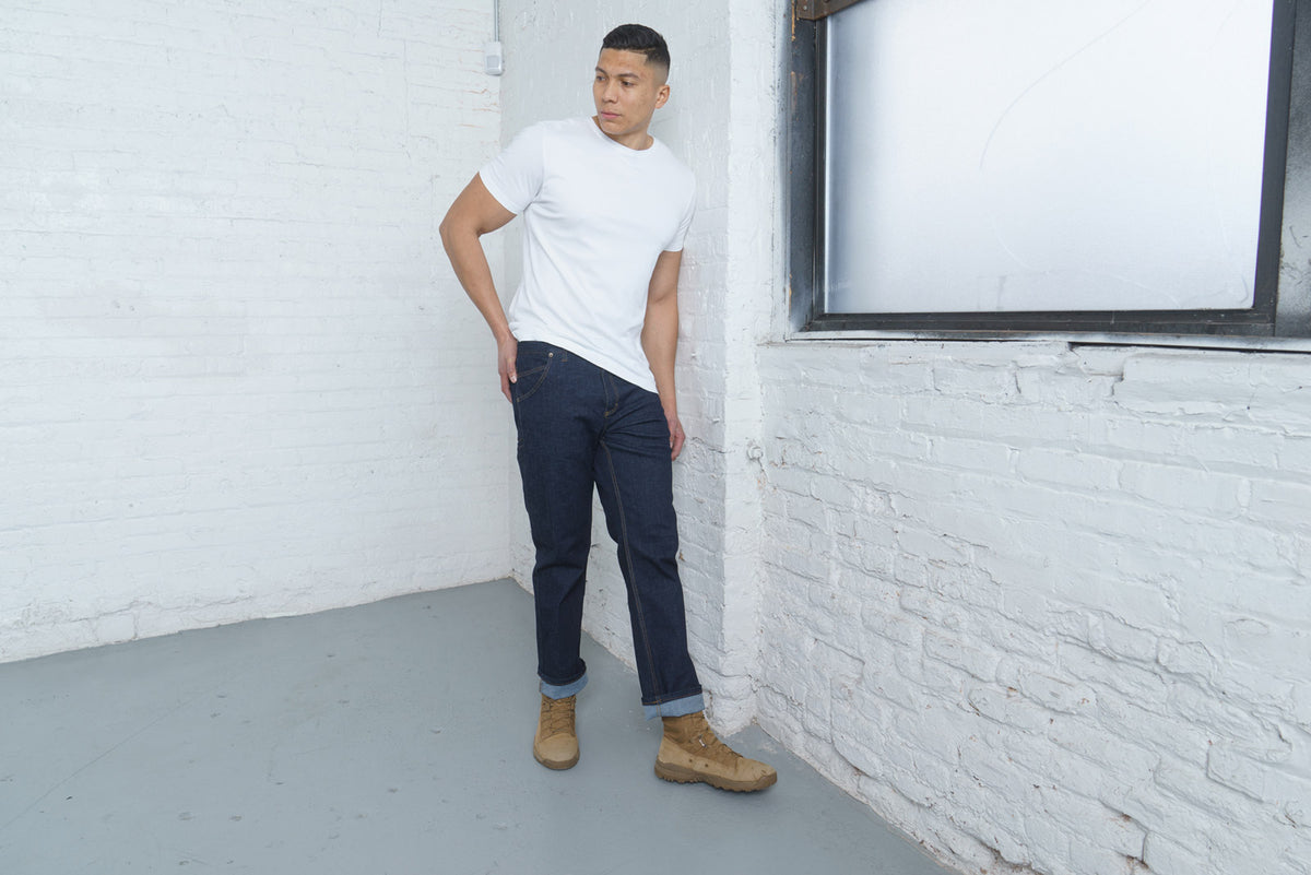 Detail of the hem and leg opening on dark wash relaxed fit jeans